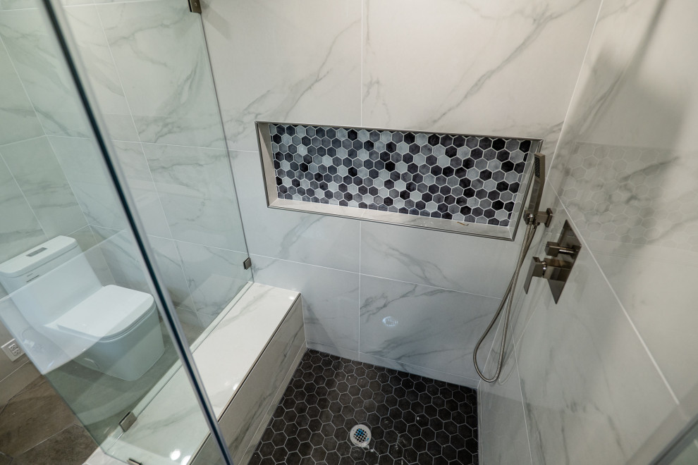 Источник вдохновения для домашнего уюта: главная ванная комната среднего размера в стиле модернизм с плоскими фасадами, серыми фасадами, отдельно стоящей ванной, угловым душем, раздельным унитазом, белой плиткой, мраморной плиткой, белыми стенами, полом из керамогранита, накладной раковиной, столешницей из кварцита, серым полом, душем с распашными дверями, белой столешницей, нишей, тумбой под одну раковину и подвесной тумбой