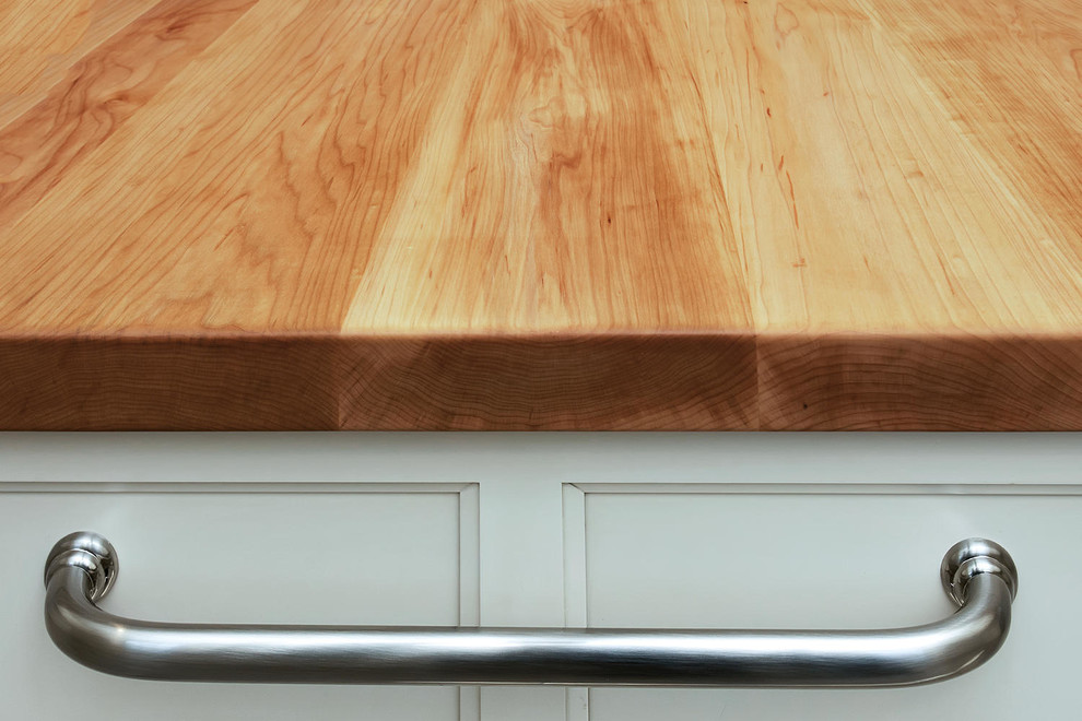 Example of a mid-sized transitional u-shaped porcelain tile eat-in kitchen design in New York with an undermount sink, recessed-panel cabinets, white cabinets, wood countertops, gray backsplash, subway tile backsplash, stainless steel appliances and an island