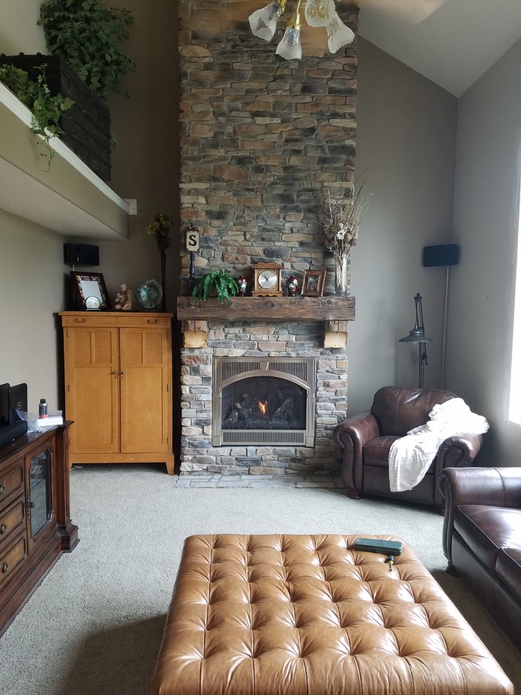 This is an example of a mid-sized traditional formal enclosed living room in Salt Lake City with grey walls, carpet, a standard fireplace, a stone fireplace surround, a wall-mounted tv and beige floor.