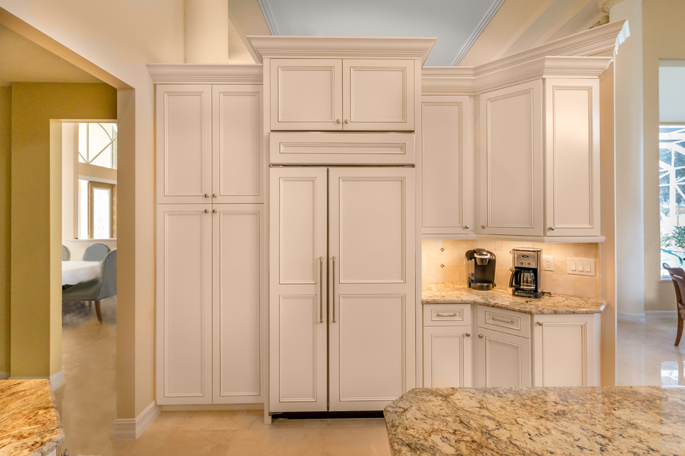 Example of a large transitional u-shaped marble floor kitchen design in Miami with a single-bowl sink, shaker cabinets, white cabinets, granite countertops, beige backsplash, cement tile backsplash, stainless steel appliances and an island