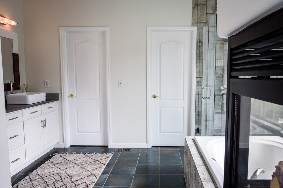 Large transitional master gray tile and glass tile concrete floor drop-in bathtub photo in Denver with white cabinets, white walls, a vessel sink, quartz countertops and shaker cabinets