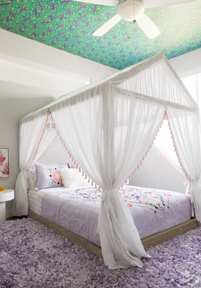 This is an example of a contemporary kids' room for girls in Dallas with white walls, dark hardwood floors, brown floor and wallpaper.