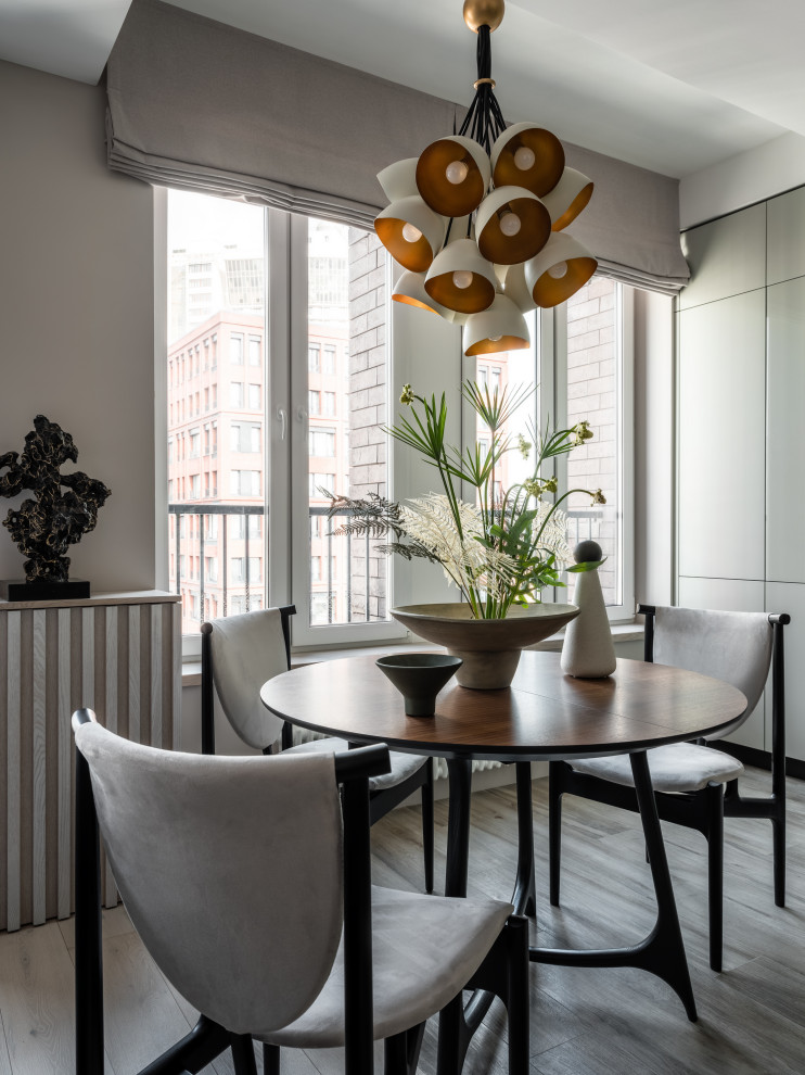 Esempio di una sala da pranzo aperta verso la cucina minimal di medie dimensioni con pareti grigie, pavimento in gres porcellanato e pavimento grigio