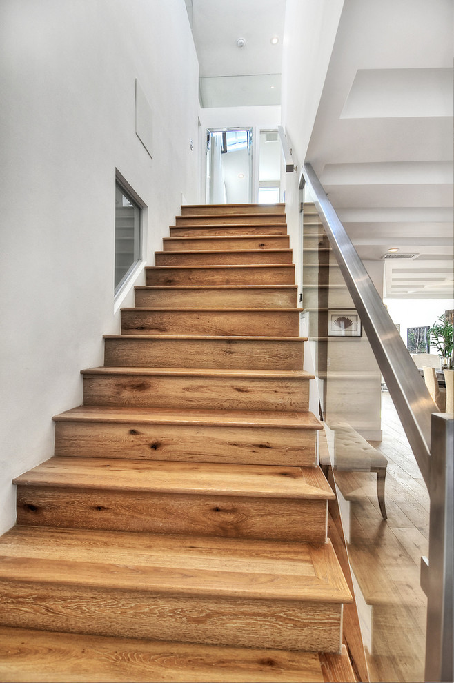 Contemporary wood straight staircase in Orange County with wood risers.