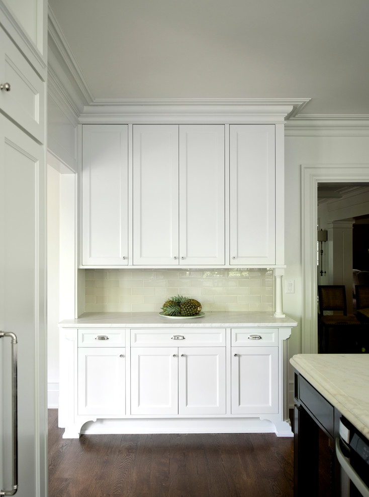 Transitional medium tone wood floor kitchen photo in Atlanta with beaded inset cabinets, white backsplash, stainless steel appliances and an island