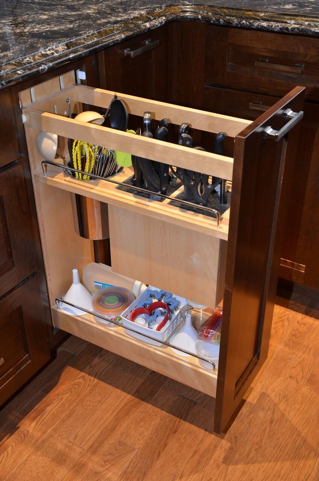 Inspiration for a large transitional l-shaped medium tone wood floor open concept kitchen remodel in Toronto with an undermount sink, recessed-panel cabinets, dark wood cabinets, quartzite countertops, gray backsplash, glass tile backsplash, stainless steel appliances and an island