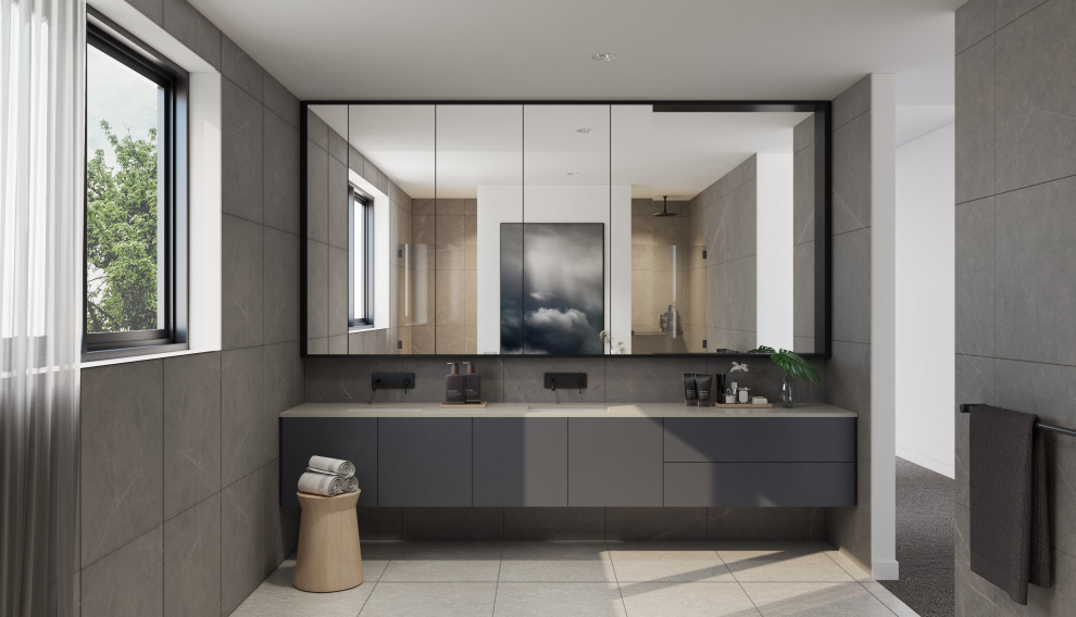 Large contemporary master bathroom in Melbourne with flat-panel cabinets, grey cabinets, a freestanding tub, an open shower, a one-piece toilet, gray tile, ceramic tile, grey walls, ceramic floors, an undermount sink, engineered quartz benchtops, beige floor, a hinged shower door, beige benchtops, a double vanity and a floating vanity.