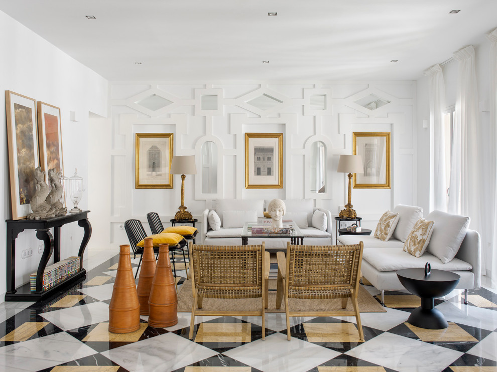 This is an example of a large mediterranean open concept living room in Seville with white walls, marble floors, no fireplace, white floor and decorative wall panelling.