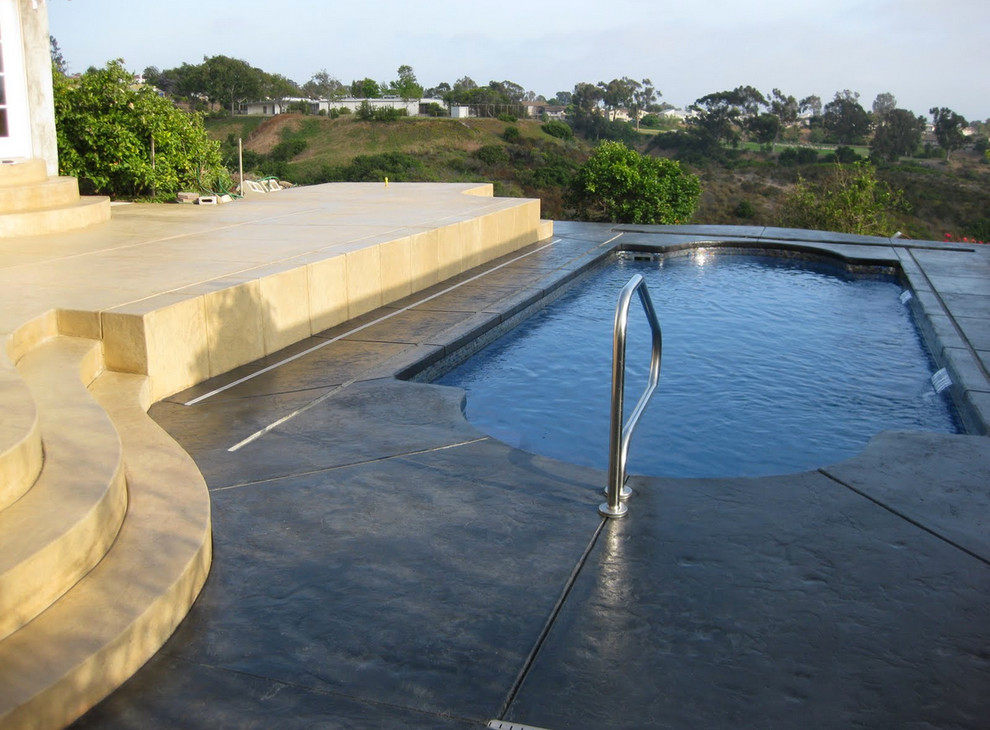 Pool - small backyard stamped concrete and rectangular natural pool idea in Cincinnati