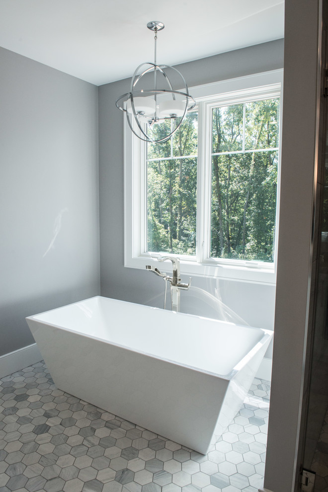 Freestanding bathtub - huge transitional master porcelain tile and gray floor freestanding bathtub idea with shaker cabinets, a one-piece toilet, gray walls, an undermount sink and gray countertops