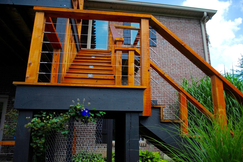 This is an example of a mid-sized contemporary backyard deck in Indianapolis with a pergola.