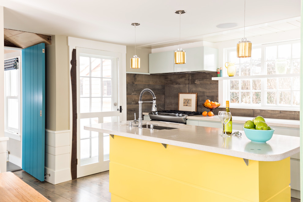 Inspiration for a mid-sized contemporary single-wall kitchen in Boston with yellow cabinets, concrete benchtops, brown splashback, porcelain splashback, with island and stainless steel appliances.