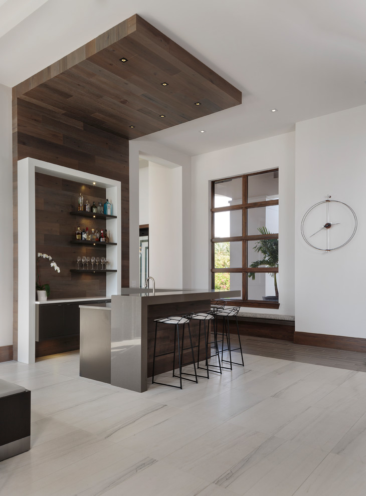 Design ideas for a mid-sized modern l-shaped seated home bar in Miami with flat-panel cabinets, beige floor, an undermount sink, brown cabinets, timber splashback and brown splashback.