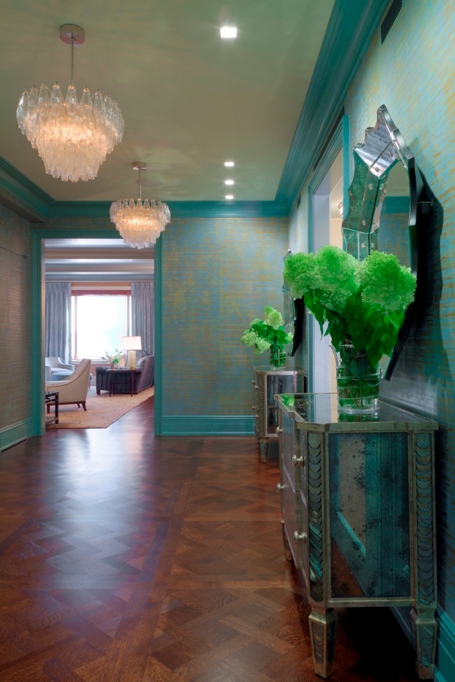 Contemporary foyer in New York with multi-coloured walls and medium hardwood floors.