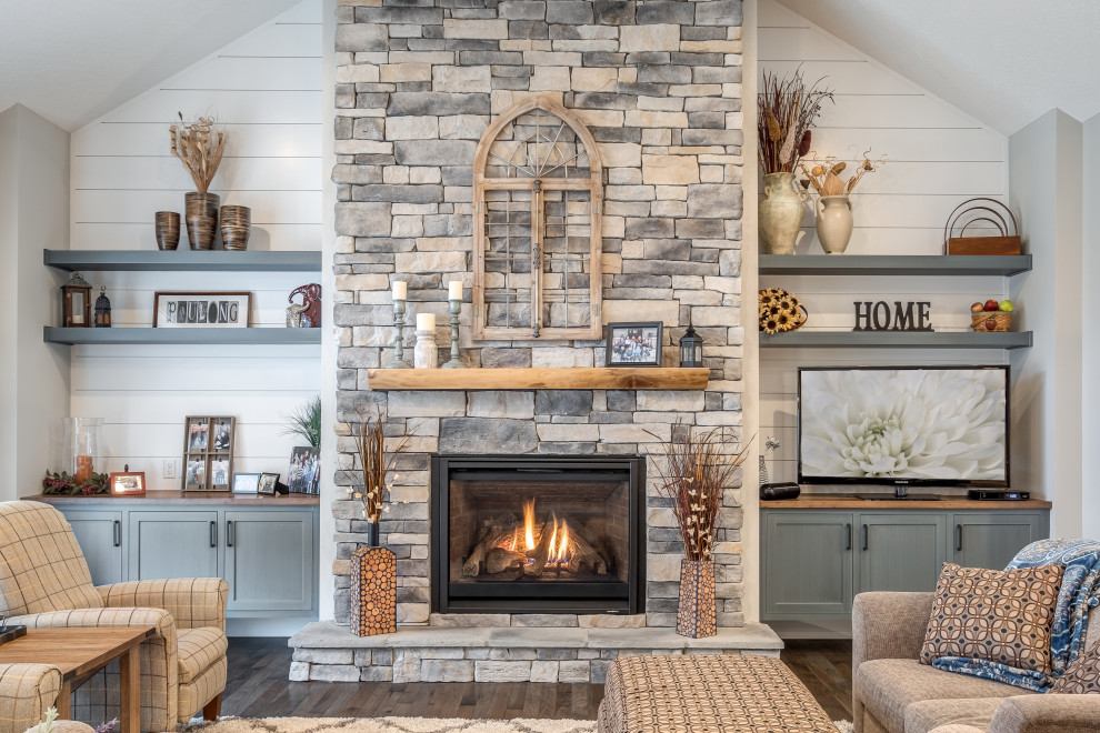 Large transitional enclosed family room in Other with white walls, dark hardwood floors, a standard fireplace, a stone fireplace surround, a corner tv and brown floor.