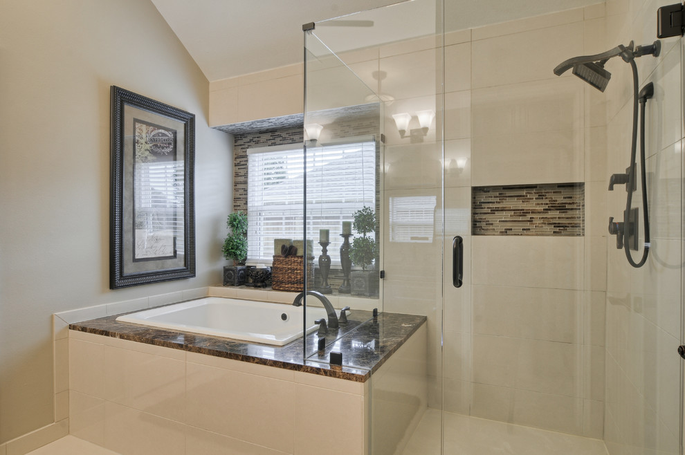This is an example of a mid-sized transitional master bathroom in Dallas with a drop-in tub, beige walls, ceramic floors, raised-panel cabinets, dark wood cabinets, a corner shower, an undermount sink and granite benchtops.