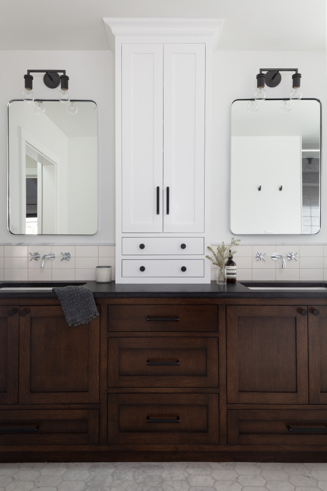 Photo of a mid-sized country bathroom in Santa Barbara with recessed-panel cabinets, dark wood cabinets, white walls, ceramic floors, an undermount sink, solid surface benchtops, white floor, black benchtops, a double vanity and a built-in vanity.
