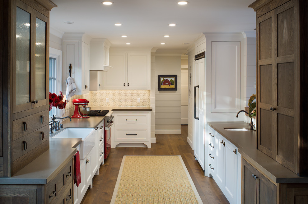This is an example of a country kitchen in San Diego with flat-panel cabinets, medium wood cabinets and a farmhouse sink.
