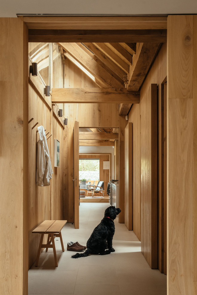 Photo of a country hallway in Surrey with beige floor, exposed beam, recessed, wood and wood walls.