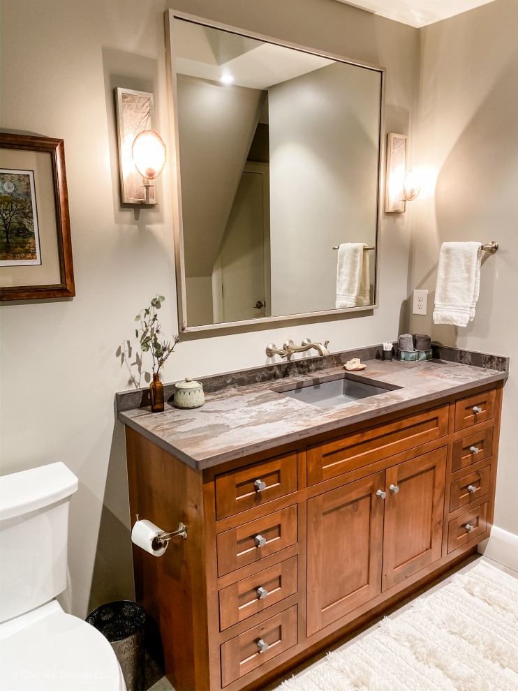 Inspiration for a rustic green tile and terra-cotta tile ceramic tile and gray floor sliding shower door remodel with shaker cabinets, brown cabinets, a two-piece toilet, gray walls, an undermount sink, quartz countertops and gray countertops