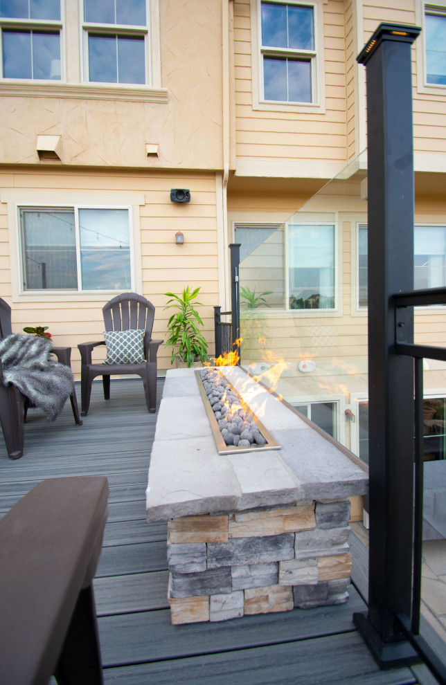 Photo of a medium sized contemporary back first floor metal railing terrace in Denver with a fire feature and no cover.