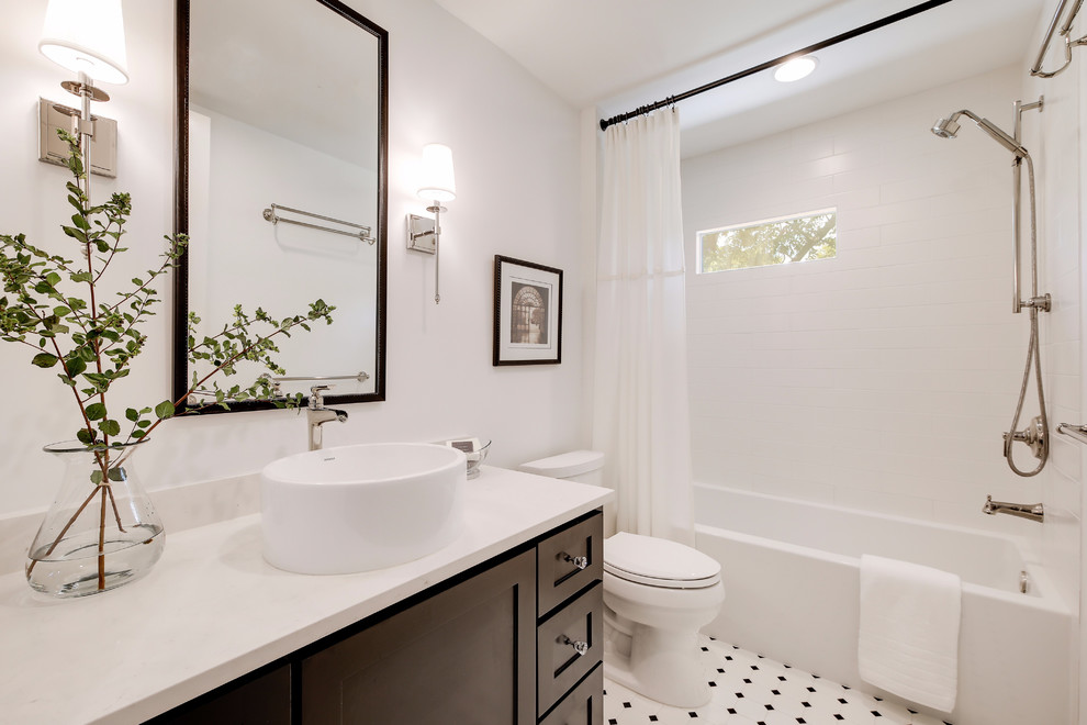 This is an example of a mid-sized contemporary master bathroom in Austin with shaker cabinets, brown cabinets, an alcove tub, an alcove shower, a two-piece toilet, white tile, subway tile, white walls, ceramic floors, a vessel sink, multi-coloured floor, a shower curtain and white benchtops.