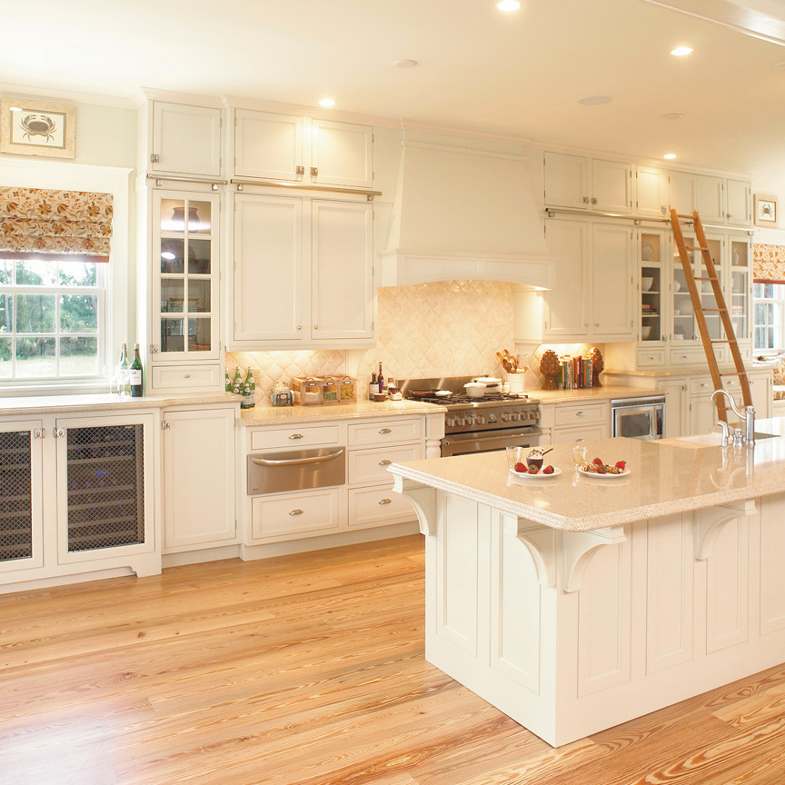 Design ideas for an expansive traditional galley eat-in kitchen in Atlanta with recessed-panel cabinets, white cabinets, light hardwood floors, a farmhouse sink, stainless steel appliances and a peninsula.
