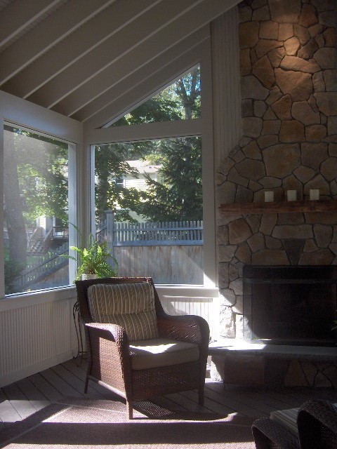 Large traditional backyard screened-in verandah in Boston with decking and a roof extension.
