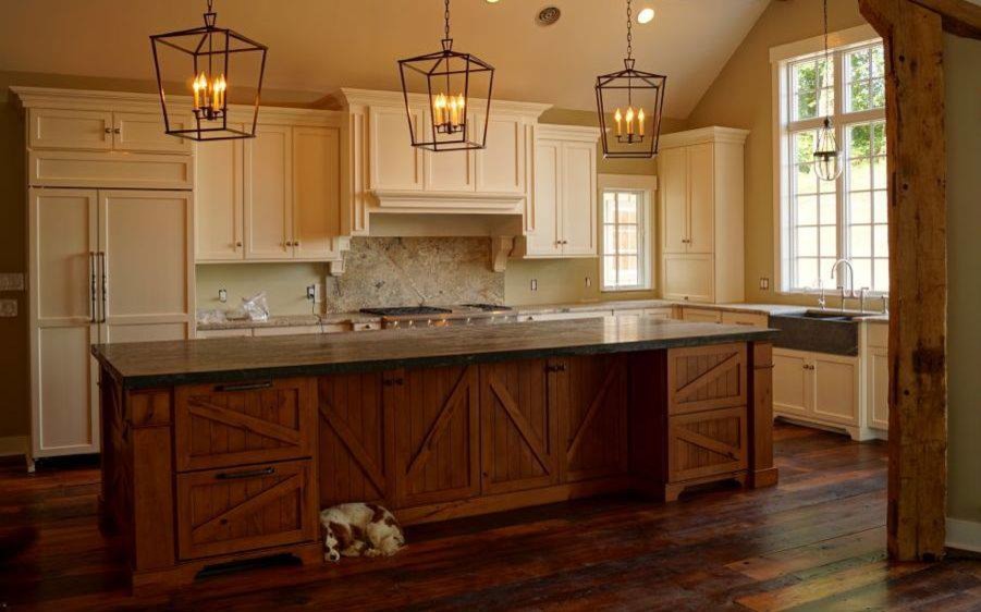 Large mountain style l-shaped dark wood floor and brown floor open concept kitchen photo in Baltimore with a double-bowl sink, white cabinets, soapstone countertops, stainless steel appliances and an island
