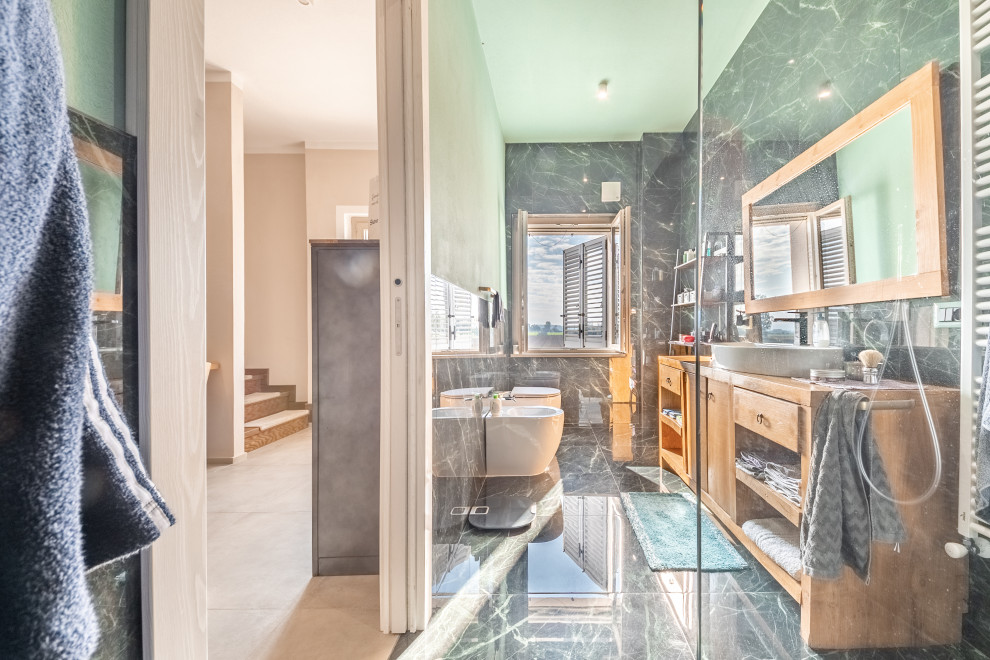 This is an example of a large modern 3/4 bathroom in Milan with open cabinets, light wood cabinets, a curbless shower, a two-piece toilet, green tile, porcelain tile, porcelain floors, a vessel sink, wood benchtops, green floor, brown benchtops, a single vanity, a floating vanity and recessed.
