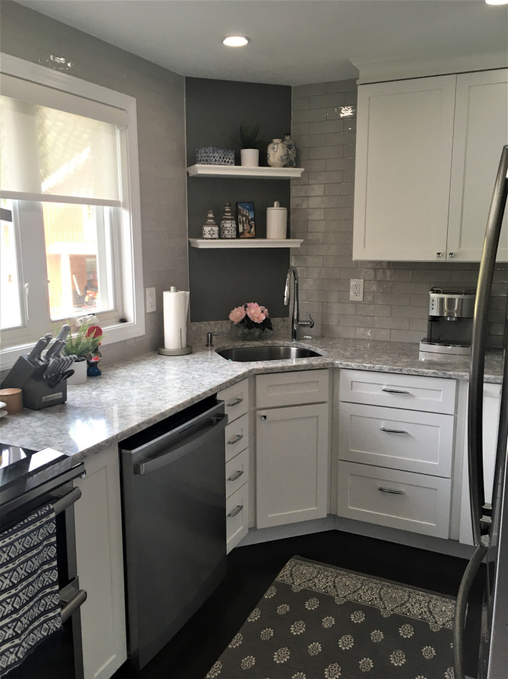 Small transitional u-shaped dark wood floor and brown floor eat-in kitchen photo in Boston with an undermount sink, shaker cabinets, white cabinets, quartz countertops, gray backsplash, subway tile backsplash, stainless steel appliances and gray countertops