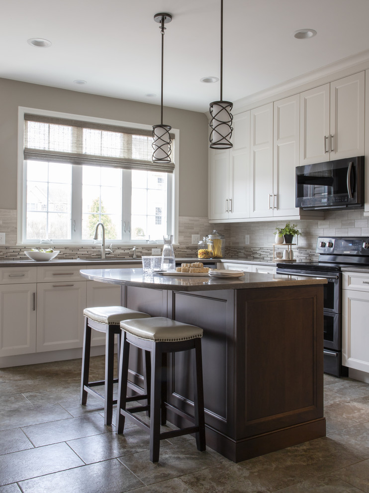 Kitchen - transitional porcelain tile and beige floor kitchen idea with an undermount sink, beige backsplash, black appliances and an island