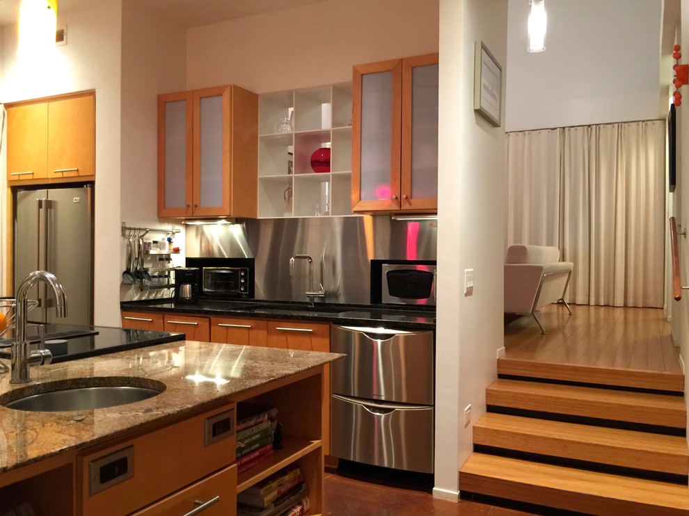 Eat-in kitchen - transitional single-wall bamboo floor eat-in kitchen idea with an undermount sink, flat-panel cabinets, light wood cabinets, granite countertops, stainless steel appliances and an island