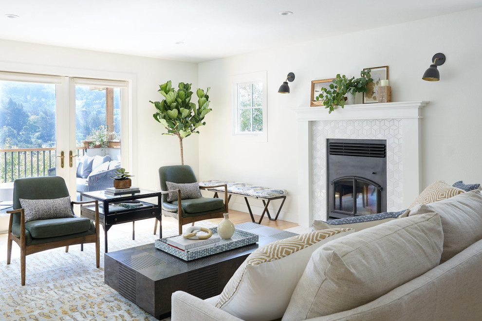 Example of a mid-sized transitional open concept medium tone wood floor living room design in San Francisco with white walls, a standard fireplace, a metal fireplace and no tv