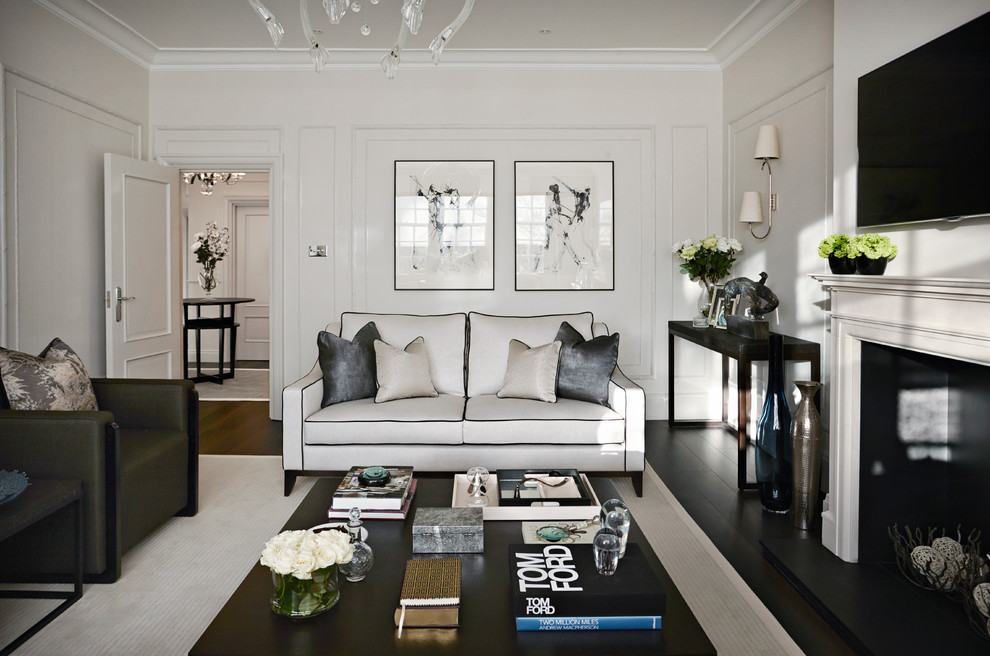 Photo of a contemporary formal living room in London with white walls, dark hardwood floors and a wall-mounted tv.
