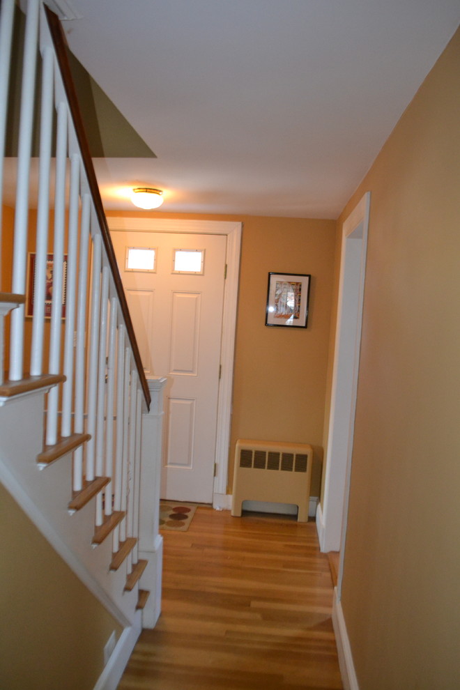 Inspiration for a mid-sized traditional hallway in Boston with beige walls and light hardwood floors.