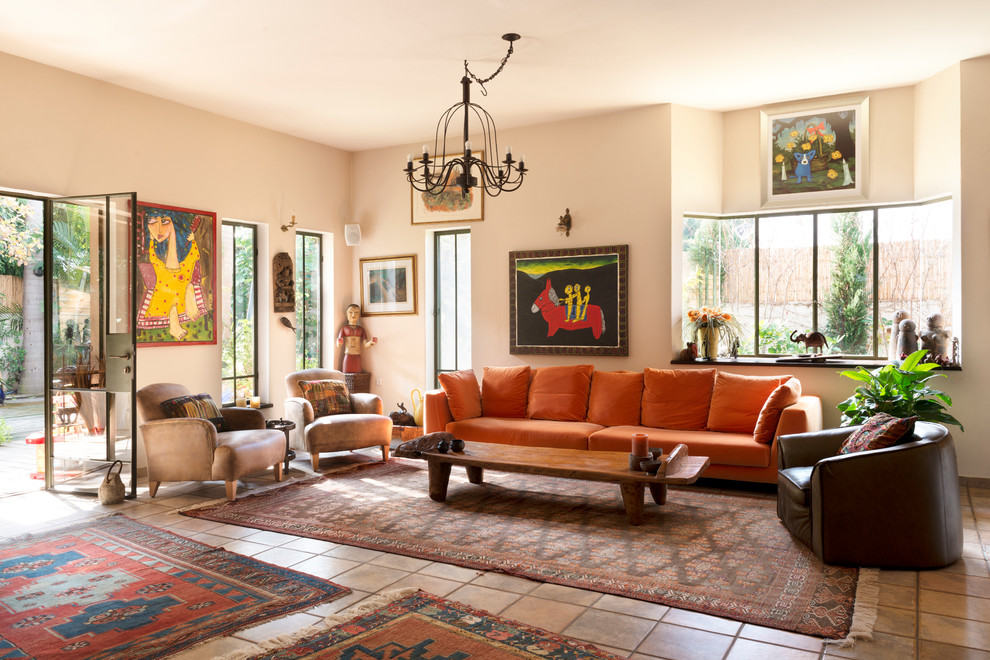 Mid-sized eclectic living room in London with beige walls, terra-cotta floors and orange floor.