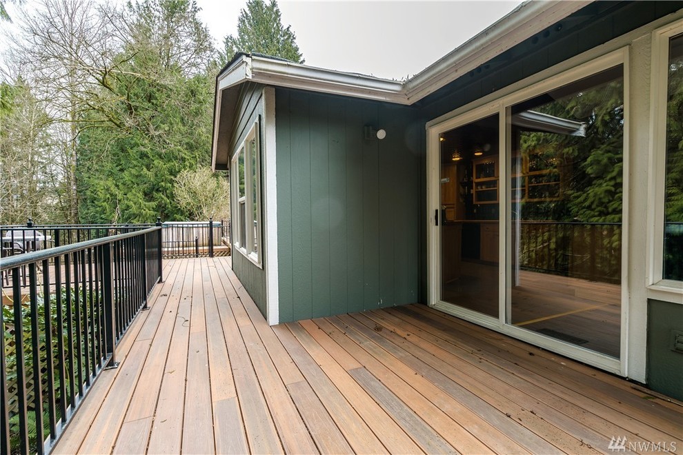 This is an example of a large contemporary backyard deck in Seattle with no cover.