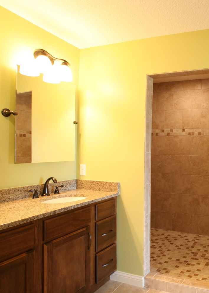 Inspiration for a transitional beige tile and ceramic tile doorless shower remodel in Chicago with medium tone wood cabinets
