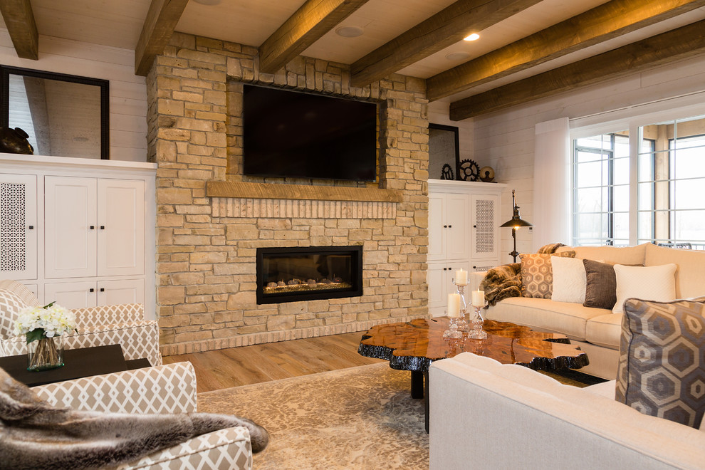 Inspiration for a large country enclosed living room in Other with white walls, light hardwood floors, a standard fireplace, a stone fireplace surround, a wall-mounted tv and brown floor.