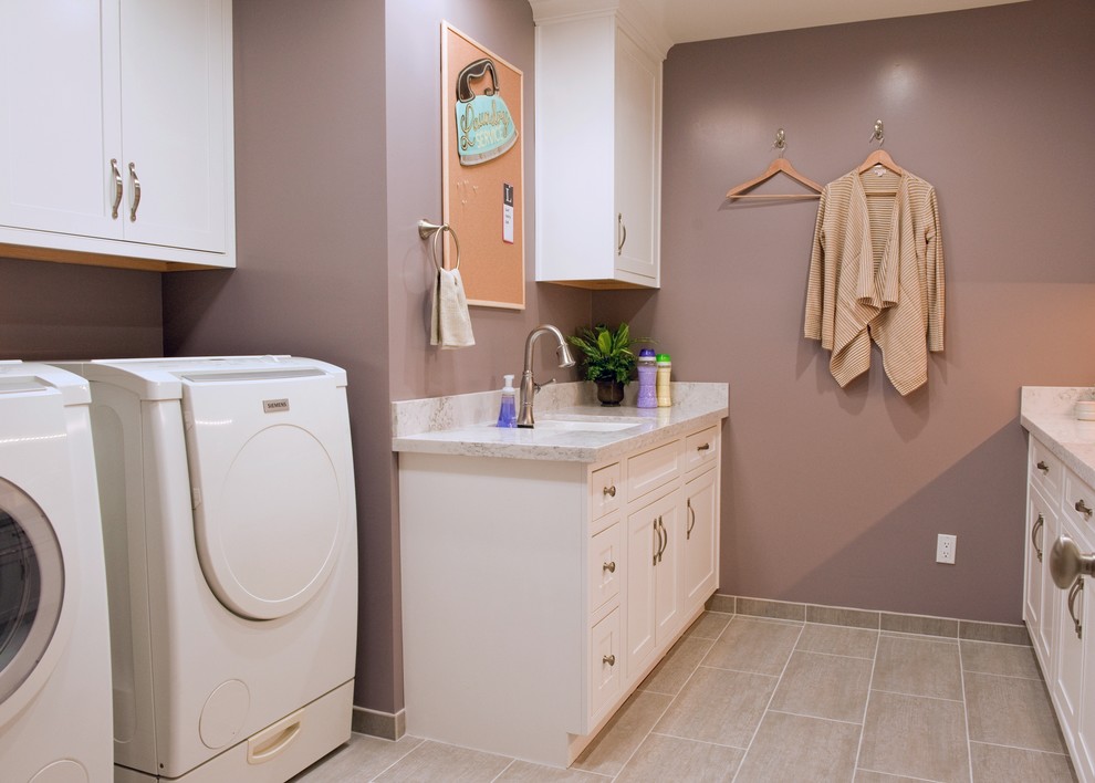 Design ideas for a large transitional u-shaped dedicated laundry room in Orange County with an undermount sink, white cabinets, quartz benchtops, purple walls, porcelain floors, a side-by-side washer and dryer and shaker cabinets.