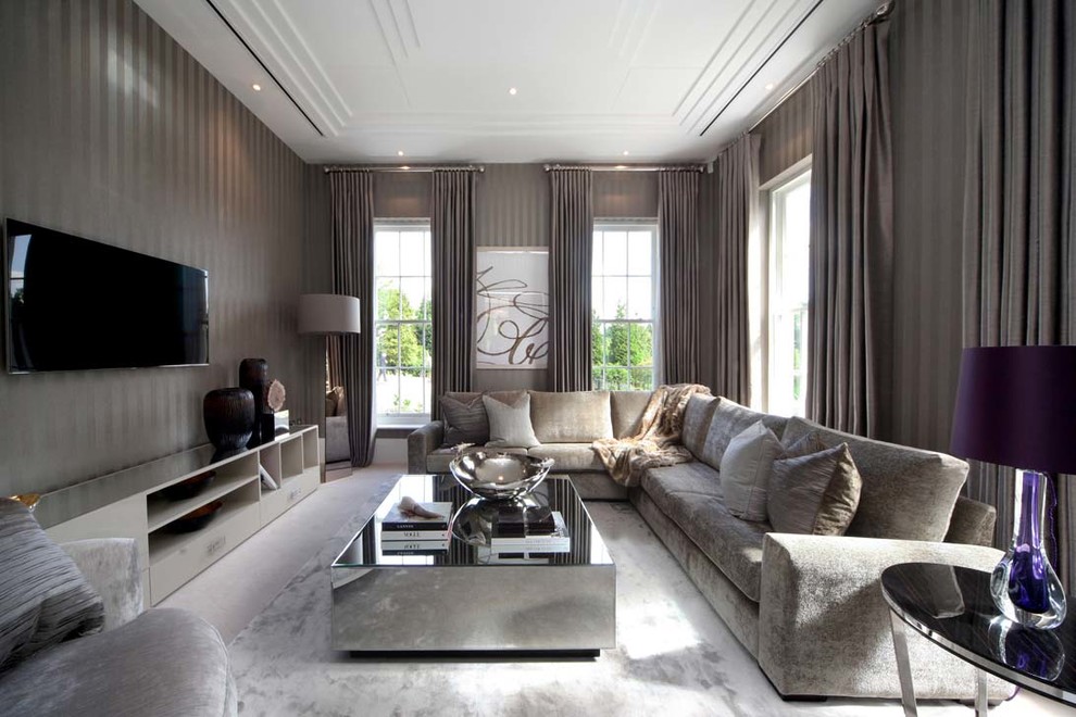 This is an example of a contemporary family room in Surrey with no fireplace, a wall-mounted tv and brown walls.