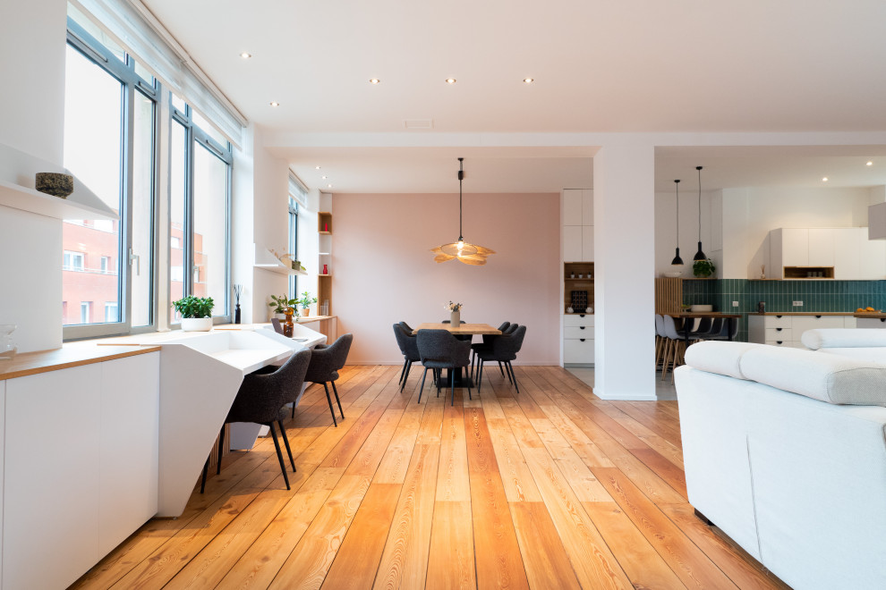 Photo of a large scandinavian dining room in Lille with white walls, medium hardwood floors and no fireplace.