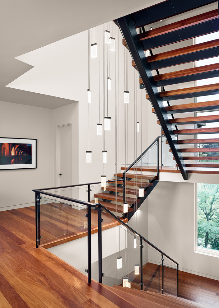 Inspiration for a large modern wood u-shaped staircase in Austin with open risers.
