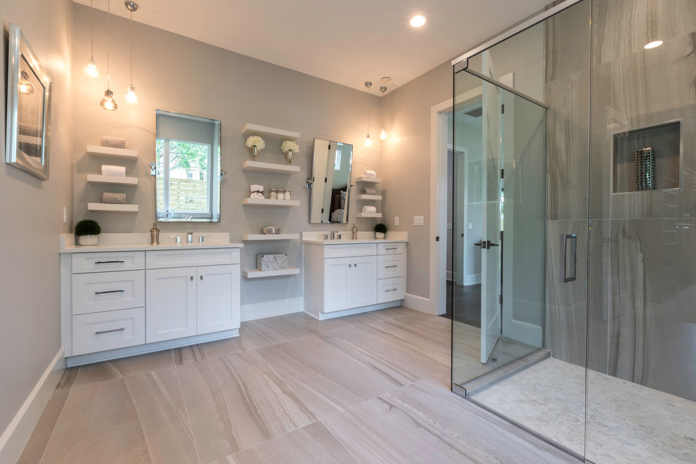 Design ideas for a large country master bathroom in Orlando with flat-panel cabinets, white cabinets, a freestanding tub, a corner shower, a two-piece toilet, gray tile, grey walls, ceramic floors, an undermount sink, quartzite benchtops, beige floor and a hinged shower door.