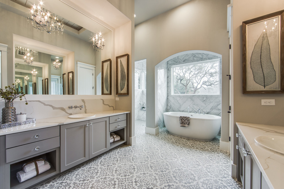 Large country master wet room bathroom in Dallas with shaker cabinets, grey cabinets, a freestanding tub, white tile, gray tile, ceramic tile, grey walls, cement tiles, engineered quartz benchtops, white floor and a drop-in sink.