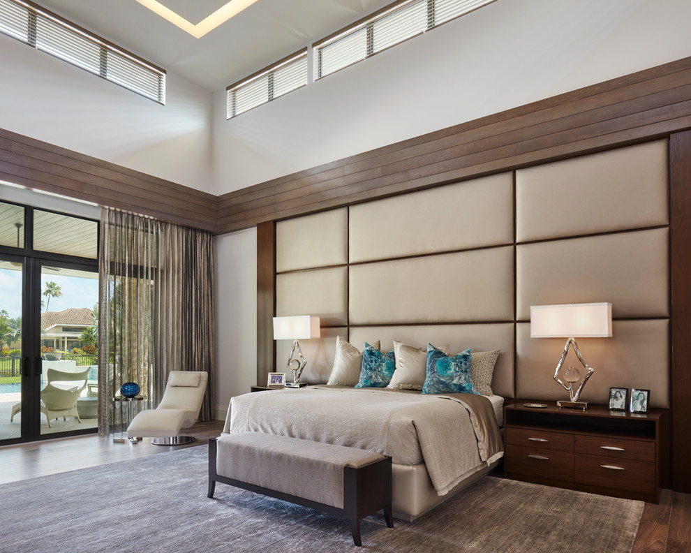 Design ideas for a contemporary master bedroom in Miami with white walls, dark hardwood floors and brown floor.