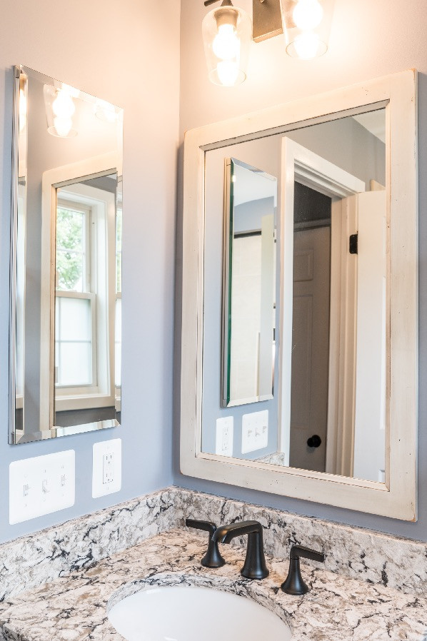 Design ideas for a small country 3/4 bathroom in DC Metro with shaker cabinets, distressed cabinets, a shower/bathtub combo, a two-piece toilet, grey walls, ceramic floors, an undermount sink, granite benchtops, brown floor, multi-coloured benchtops, a single vanity and a built-in vanity.