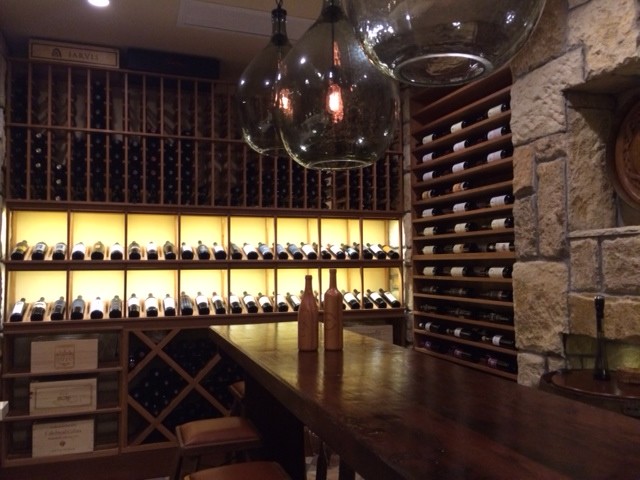 This is an example of a large country wine cellar in New York with display racks.