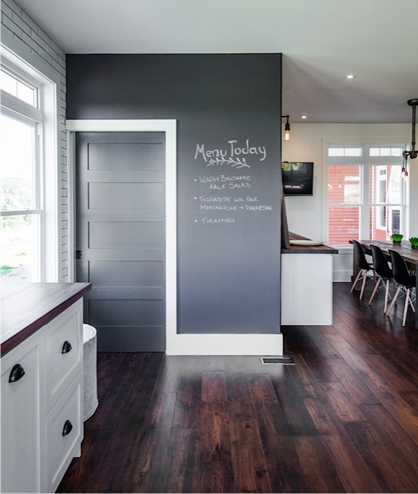 Example of a large mountain style u-shaped medium tone wood floor eat-in kitchen design with an integrated sink, shaker cabinets, green cabinets, concrete countertops, white backsplash, subway tile backsplash, stainless steel appliances and an island